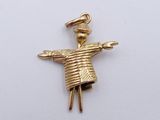a picture of a small gold figurine with a hat on it ' s head