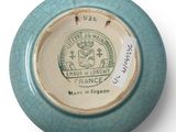 a close up of a blue and white plate with a crest on it