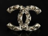a chanel broocher made out of silver metal