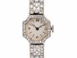 an image of a lady ' s wrist watch with diamonds and blue leather strap