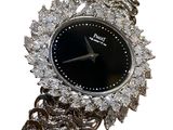 an image of a close up of a wrist watch with a chain around it