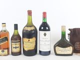 several bottles of liquor are lined up on a white surface