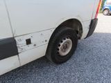 a white van that has been vandalized and is parked on the side of the road