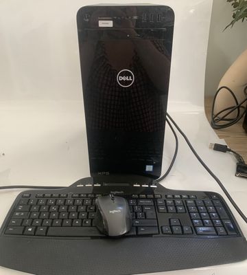 a dell laptop and a mouse on a desk