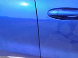a close up of a blue car door handle