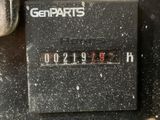 a close up of a clock on a black surface