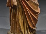 an antique statue of a woman holding a baby in her arms