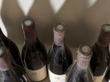 several bottles of wine are lined up in a row on a table