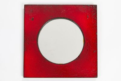 a red picture frame with a white circle in it