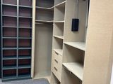 a walk in closet with a lot of shelves and drawers