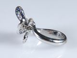 a silver ring with a blue and white diamond on it