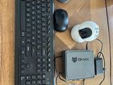 a computer keyboard and mouse on a wooden desk