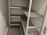 a pantry with shelves and shelves that have holes in them