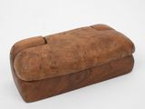 an old wooden box sitting on top of a white surface