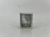 a small glass block with a picture of a tree on it