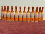 six bottles of champagne lined up in a row on a table