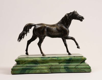 bronze statue of a horse on a marble base