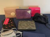 many different purses on a table with a blue table cloth