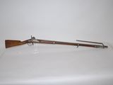 an old rifle with a wooden handle on a white surface