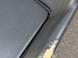 a black leather chair with a hole in the seat