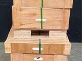 four wooden boxes stacked on top of each other on a pallet