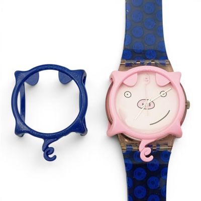 a watch with a cat face on it next to a blue watch band