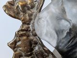a sculpture of a seashell on a glass table