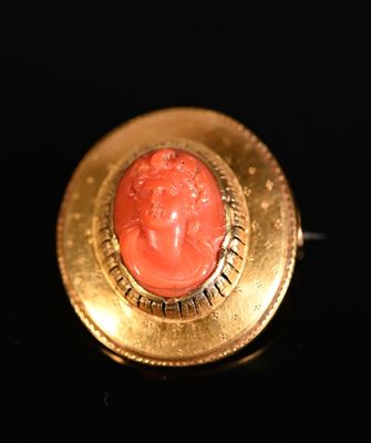 an image of a gold ring with a red stone in the center