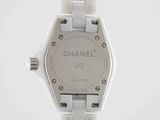 a close up of a watch on a white surface