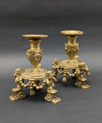 pair of antique brass candlesticks with cherenshes and cherenshes