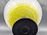 a glass vase with a black base and a yellow base
