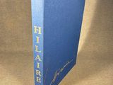a blue book with gold lettering on it sitting on a table