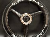 a close up of a wheel on a black surface