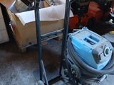 an image of a cart with a vacuum on it in a garage