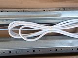 a white cord that is attached to a metal object
