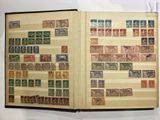 an open book with stamps on it on a table