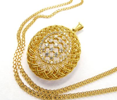 collier plaqué or composé d'une chaîne et d'un pendentif orné d'un motif floral