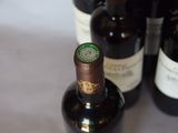 several bottles of wine are lined up on a table