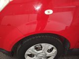 a close up of a red car with a white door