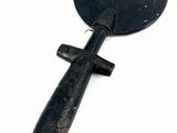 a small black object with a wooden handle on a white surface