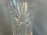 a clear glass vase sitting on a wooden table