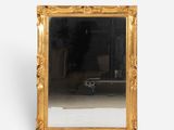 a mirror that is sitting on the floor in front of a white wall