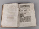 an open book with a black and white image of a man ' s face on it