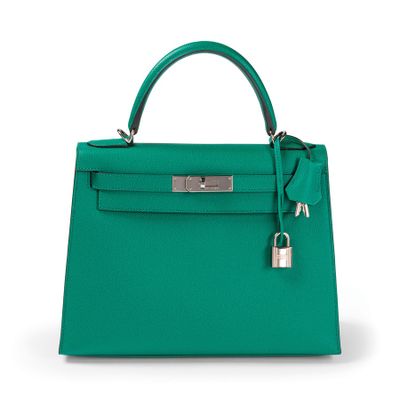 a green leather handbag on a white background