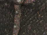 a close up of a black sweater with silver buttons on it
