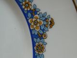 un gros plan sur une assiette ornée de fleurs bleues et jaunes