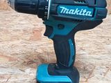 a cordless drill that is sitting on top of a piece of plywood