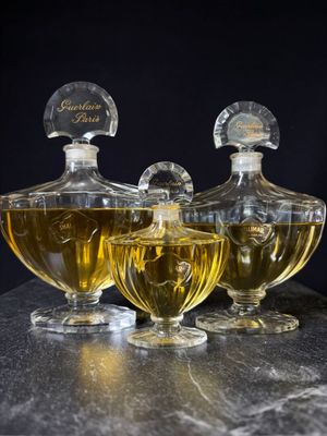 three bottles of perfume sitting next to each other on a table