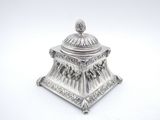 an antique silverplated sugar dish with a domed lid on a white background