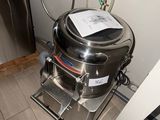 a stainless steel kettle sitting in a kitchen next to a refrigerator